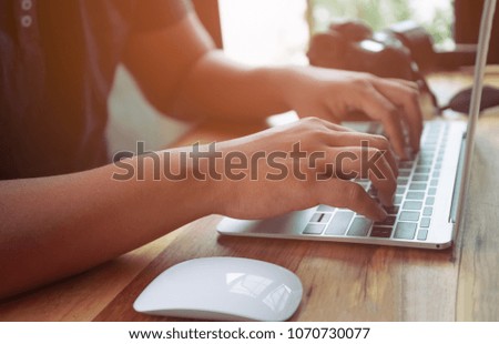 photographer use  laptop for working and process picture after take a photo