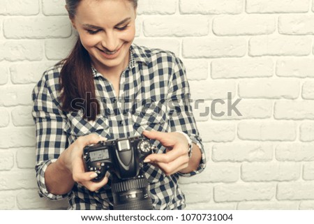 Pretty woman is a professional photographer with dslr camera
