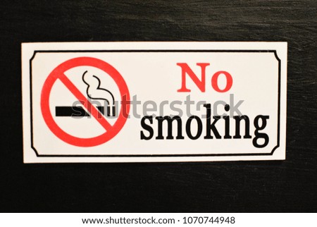 Photo of a no smoking area signage and warning sign