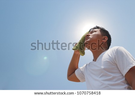 Young man and heat stroke. Royalty-Free Stock Photo #1070758418