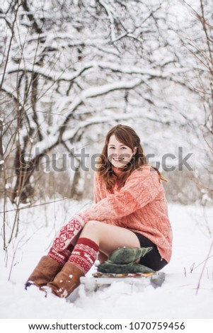 Pretty young woman on a sledge