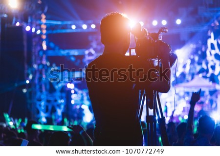 Cameraman shooting and recording video action film production professional digital camera videographer making in concert music festival event at the party background, television media Royalty-Free Stock Photo #1070772749