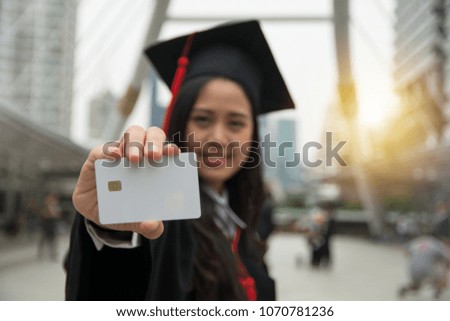 Graduated student holding a blank smart card in hand