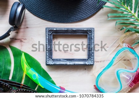 summer holiday with sunglasses, snorkel and headphone on wood background, summer colorful concept, flat lay view