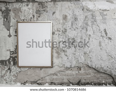 Golden frame with white background inside on crack tiles wall / crack tile concept / Rustic Interior