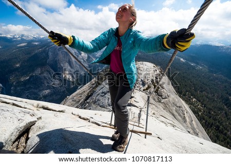 Climbing up the famous cables to the top of Half Dome. Royalty-Free Stock Photo #1070817113