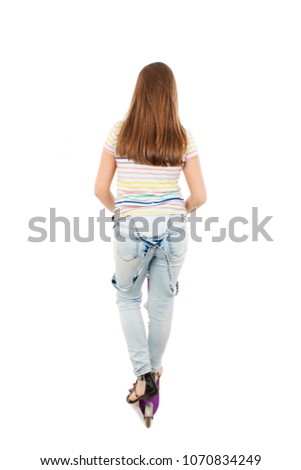Rear view of adorable teenage girl using a scooter looking on wall. Isolated on white background