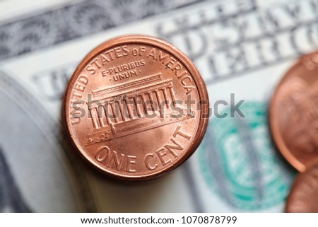 Close up of US cent coins on dollar bill background