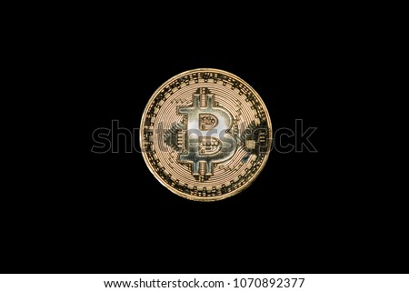 Golden bitcoin coin on black