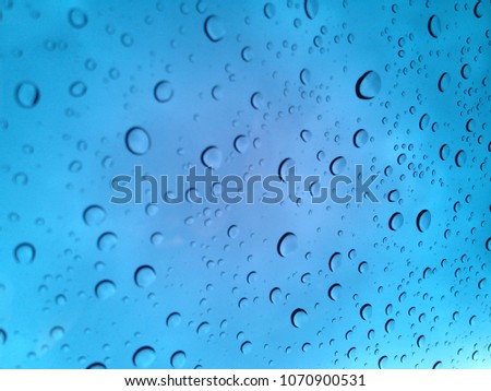 Water droplets on glass blue