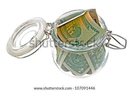 Different money in the glass jar isolated on white background