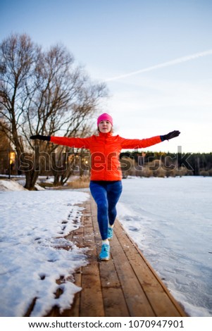 Image of young athlete girl on morning exercise in winter