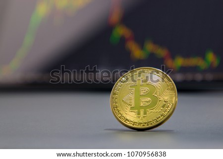 Golden bitcoin and stock chart background. 