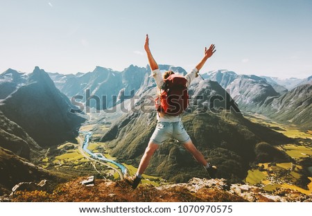 Happy Man traveler jumping with backpack Travel Lifestyle adventure concept active summer vacations outdoor in Norway mountains success and fun euphoria emotions   Royalty-Free Stock Photo #1070970575