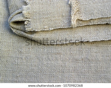Canvas closeup. Handmade textile  - natural fabric of flax in vintage style. Homespun fabric of handwork.