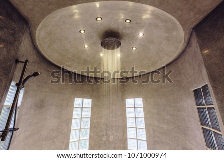Modern luxury shower design in villa interior. Concrete walls, minimalism 