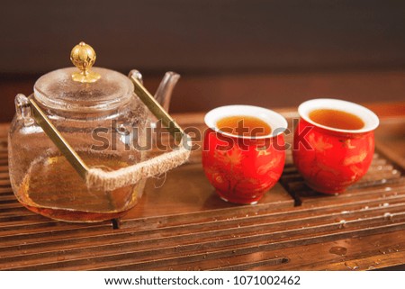 Chinese tea ceremony, puer tea in assortment kettle and tea bowls