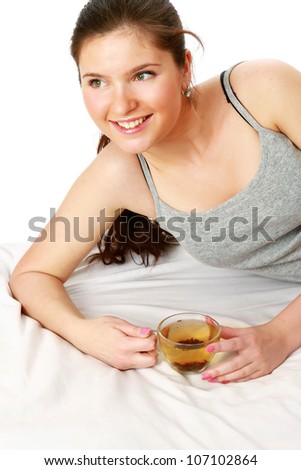A young girl with a cup of tea, isolated on white background