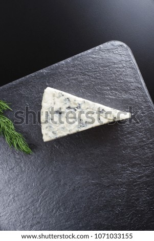 blue cheese on a dark stone background
