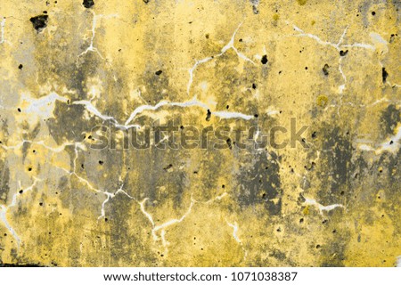 Concrete yellow and gray old dilapidated ancient flat stone wall texture with veins, divorces, patterns, cracks, pores and holes background