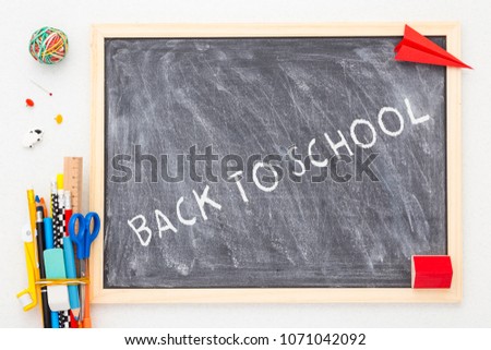 Blackboard mock up and school supplies. Back to school concept.