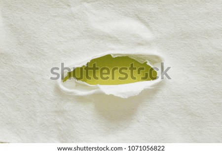 hole torn paper isolated on yellow paper background with copy space for text