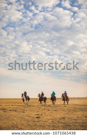 Cowboys riding the open range