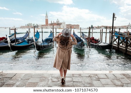 Young woman in a hat on a background of water in Venice