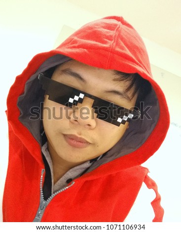 the asia hipter in the red hood with 8 bit sunglasses