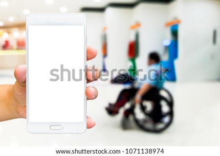 
Man  use mobile phone, blur image of disabled people selling lottery ticket as background.
