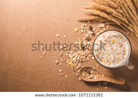 A cup of milk with cereal on wooden table. Healthy breakfast concept. copy space. top view Royalty-Free Stock Photo #1071152381