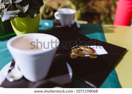Empty coffee cup on a table. Check please. Coffee and check.