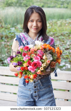 woman holding flowers bouquet in hand and smiling