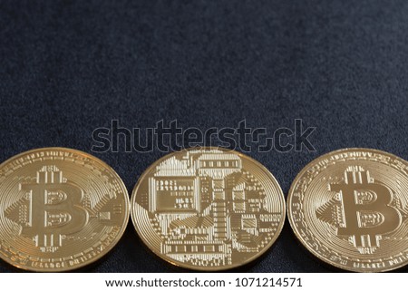 Macro view of shiny coins with a beatcoin symbol on a dark background.