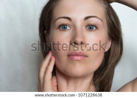 Portrait of a young girl without make-up close-up. The concept of skin care. The first signs of aging.