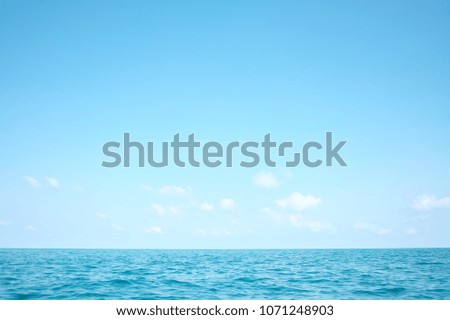 Deep blue sea with water waves and horizon line against white fluffy clouds,deep blue sea in the south of Thailand 