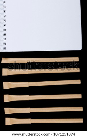 many beige pen on the dark background close up top view mock up
