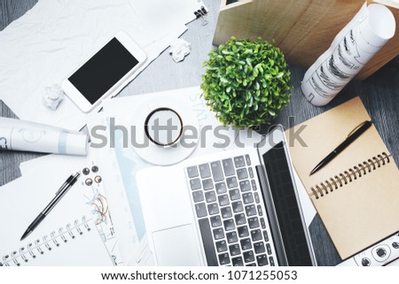 Mix of office supplies, laptop and smartphone on modern wooden workplace with other objects. Above view. Mock up 