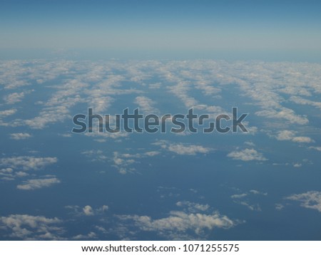 Blue sky and cloud formation panorama as seen through window of an aircraft above Europe in 2018