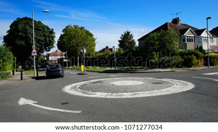 A small roundabout at local residential area in New Malden, Kingston Upon Thames, London, nobody present, blue sky in the background.