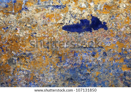 A crumbling orange and blue grunge wall