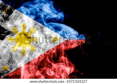 National flag of Philippines from thick colored smoke on a black isolated background