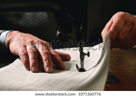 Tailoring. in ancient tradition of Italian tailors it is sewing a shirt . concept of tradition and Italian designer clothing.