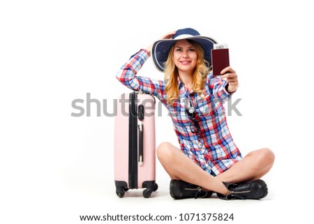 Photo of seated woman in hat with suitcase isolated on white background