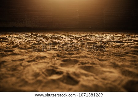 Sandy Rodeo Arena in the Warm Spotlight Closeup Photo. Royalty-Free Stock Photo #1071381269