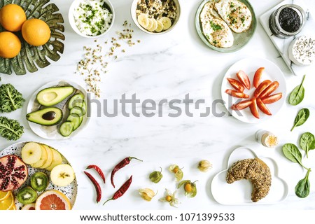 Photography of variuos bio fruits and vegetables on the marble table. Healthy food background with copy space for menu or slogan..