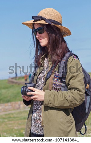 A girl with travelling equipment and a camera