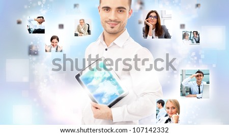 Portrait of young happy man sharing his photo and video files in social media resources using his modern tablet computer