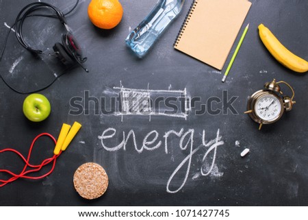 concept saving energy different methods healthy food right life style supply sport water music black background symbol charging battery chalkboard copy space top view