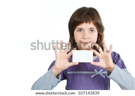 Portrait of a cute 9-year-old girl holding a blank card, smiling into camera - isolated on white